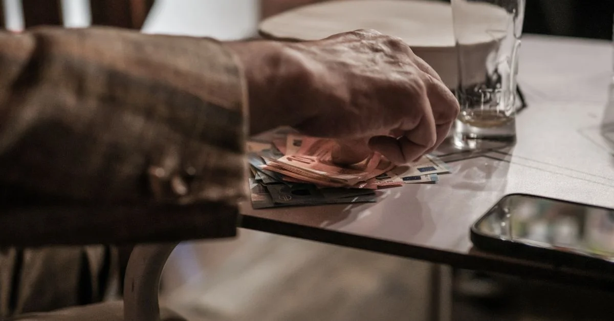Elle comptait à la main des billets en euros posés sur une table à côté d'un téléphone et d'un verre vide.